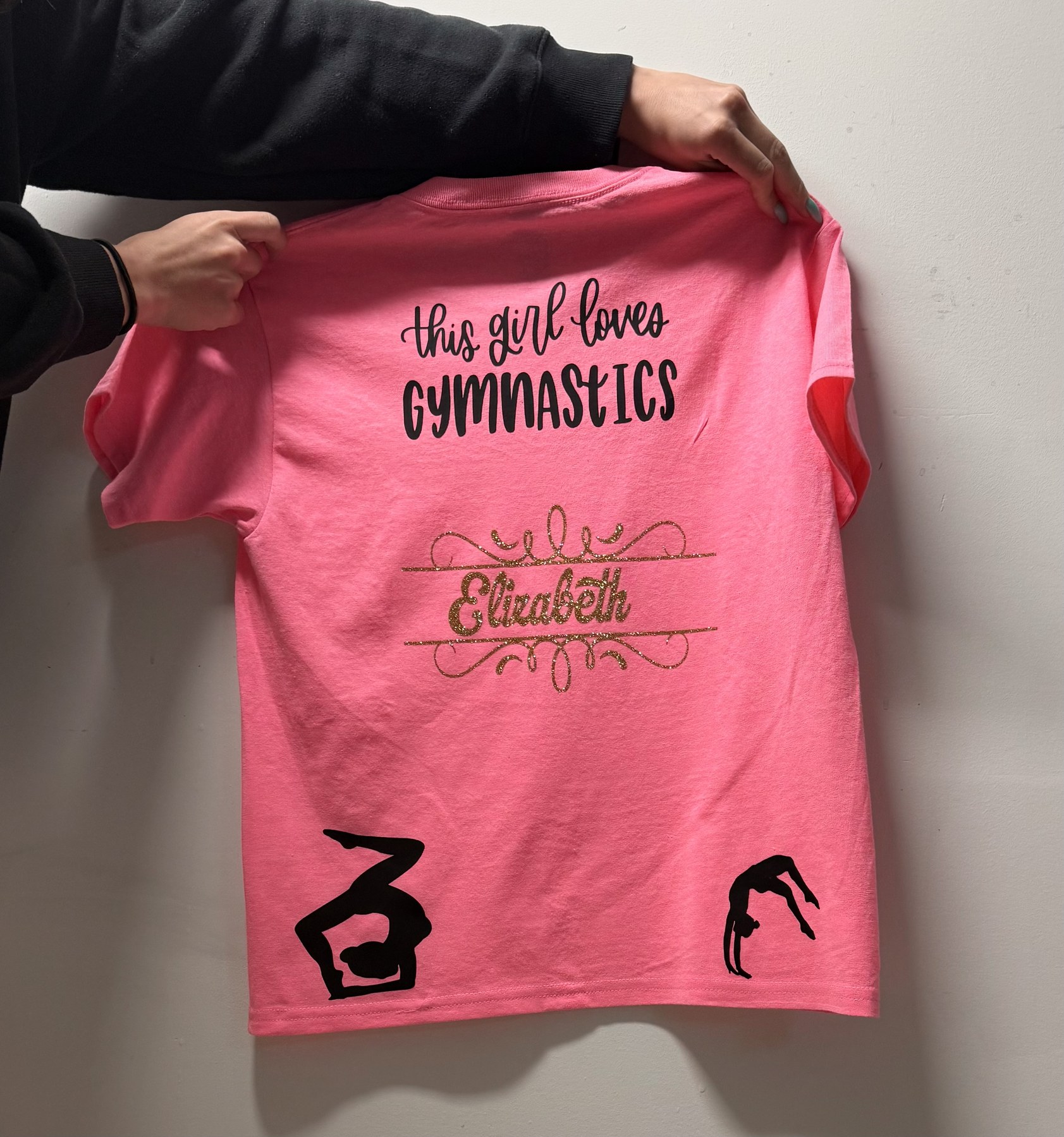 Personalized pink gymnastics T-shirt with black and gold lettering