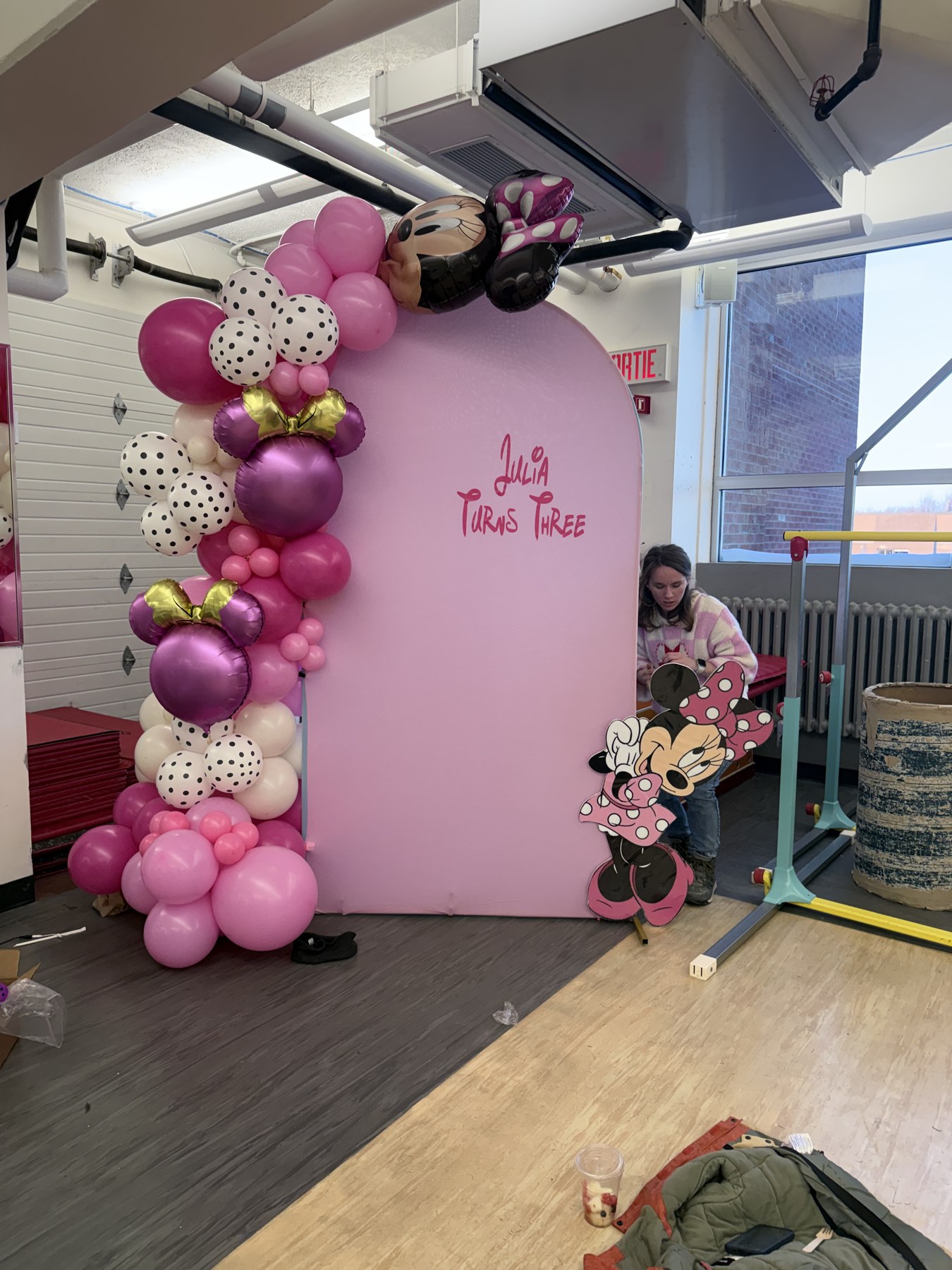 Pink Minnie Mouse third birthday backdrop with balloon garland